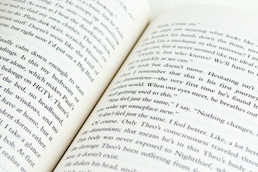 Cropped section of an open book with text.